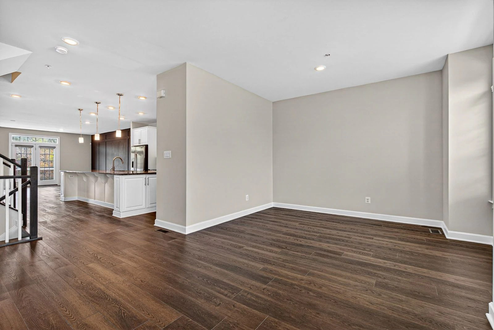 Freshly painted light walls and crisp white trim in an open living room